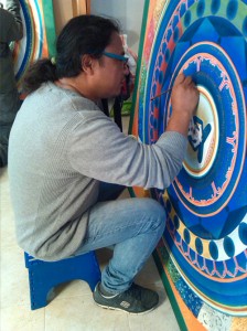 Migmar Tsering applying the gold lettering. Photo Nikol Stanisova