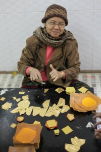 Very thin gold leafs being prepared in the traditional way. Gold leaves are placed on sacred images by Buddhist devotees