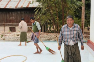 Devotees sweeping the temple grounds