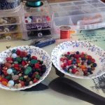 two bowls containing beads for evolution creations